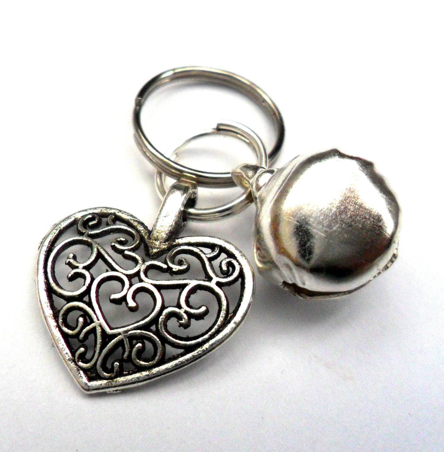 Salmon Oscar filigree heart pet charm attached to a collar, designed for leashes and petwear, showcasing intricate metalwork.