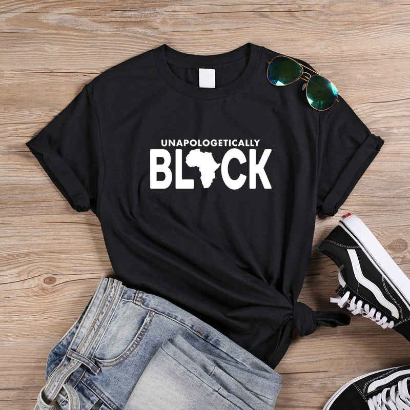 Unapologetically Black T-shirt by Olive Dionysus featuring bold black text on a comfortable fabric shirt.