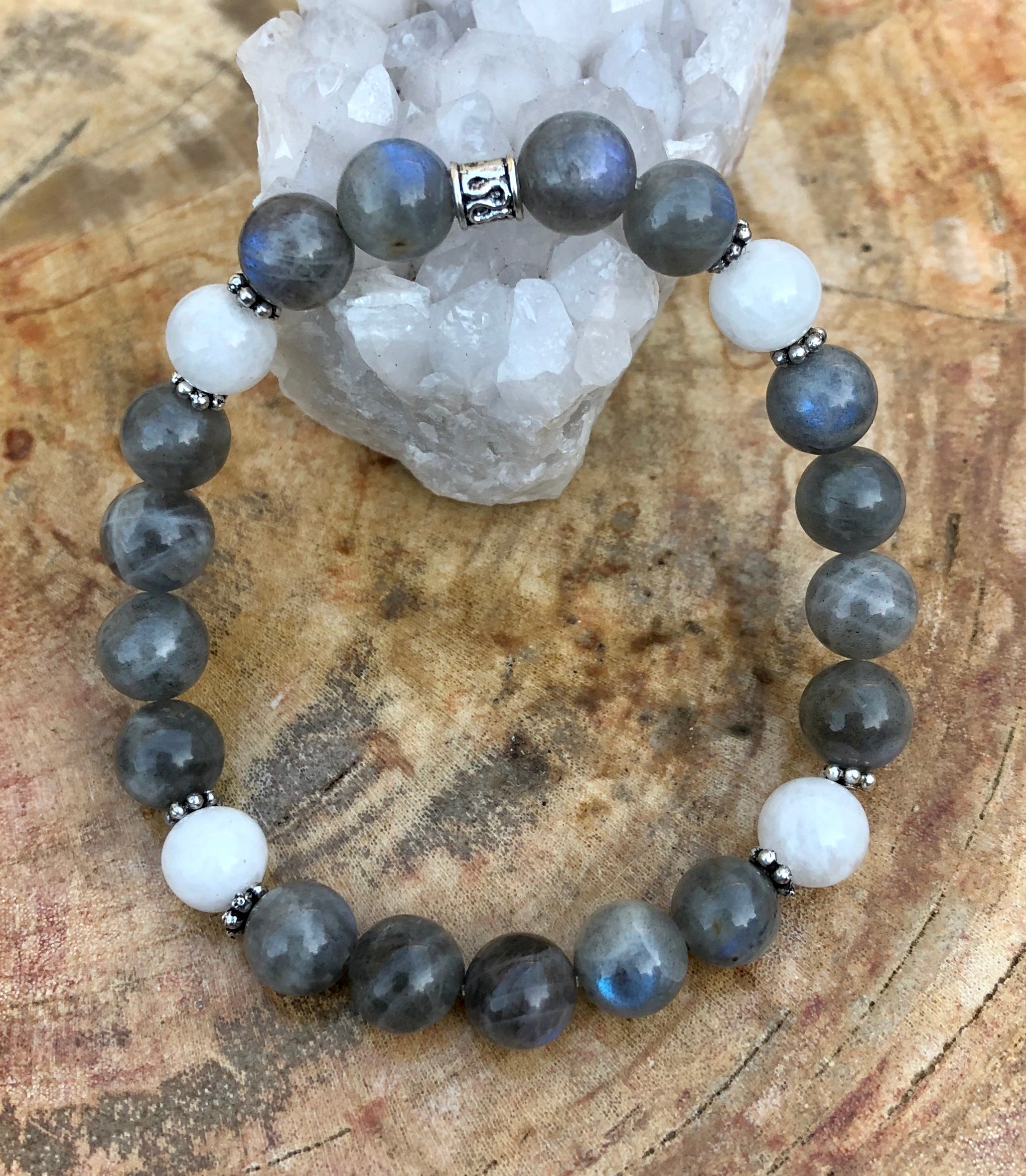 Blue flash labradorite and rainbow moonstone stretch bracelet featuring vibrant stones on a clear elastic band.
