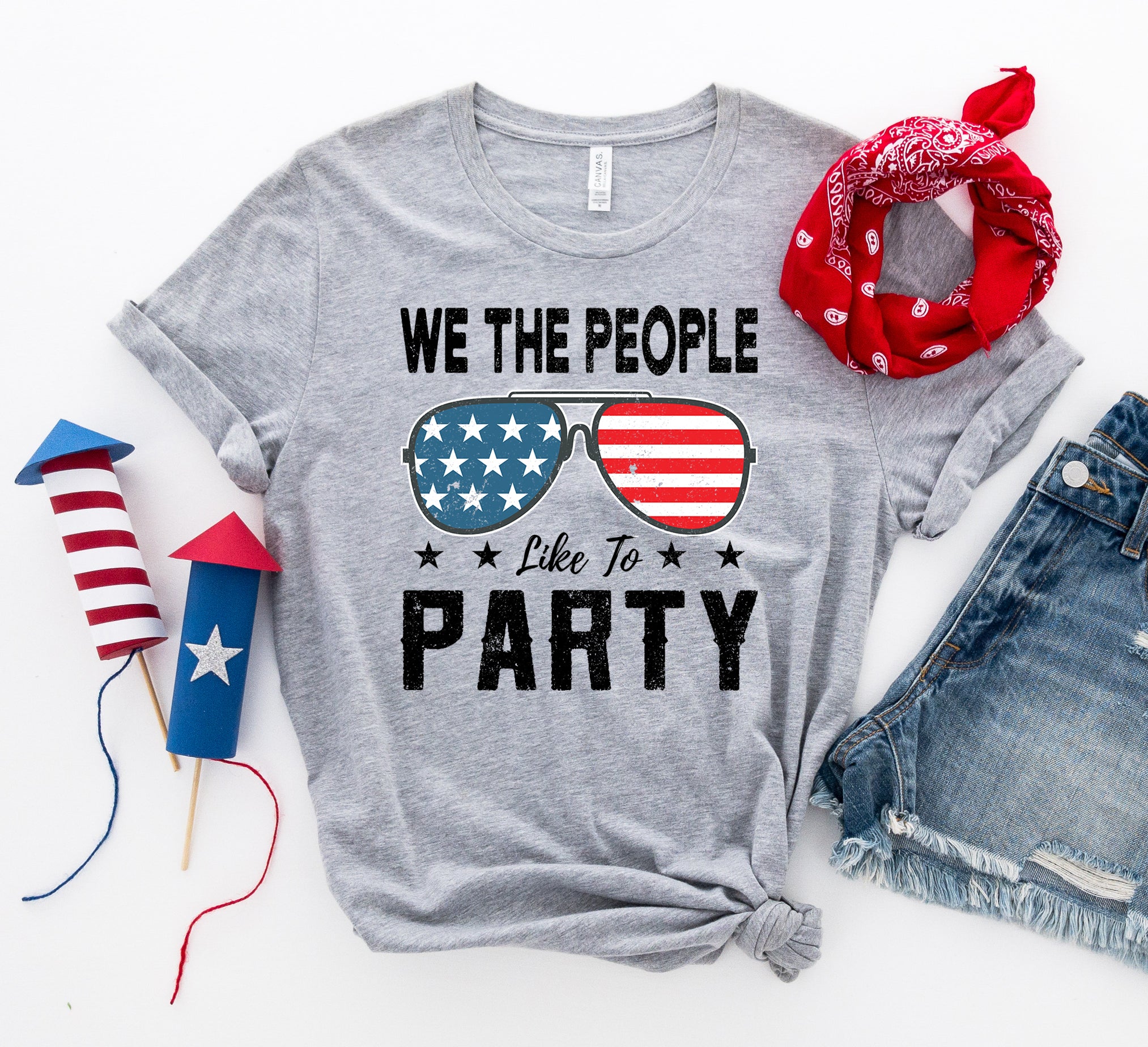 Agate "We The People Like To Party" T-shirt featuring bold text and casual fit, displayed on a hanger.