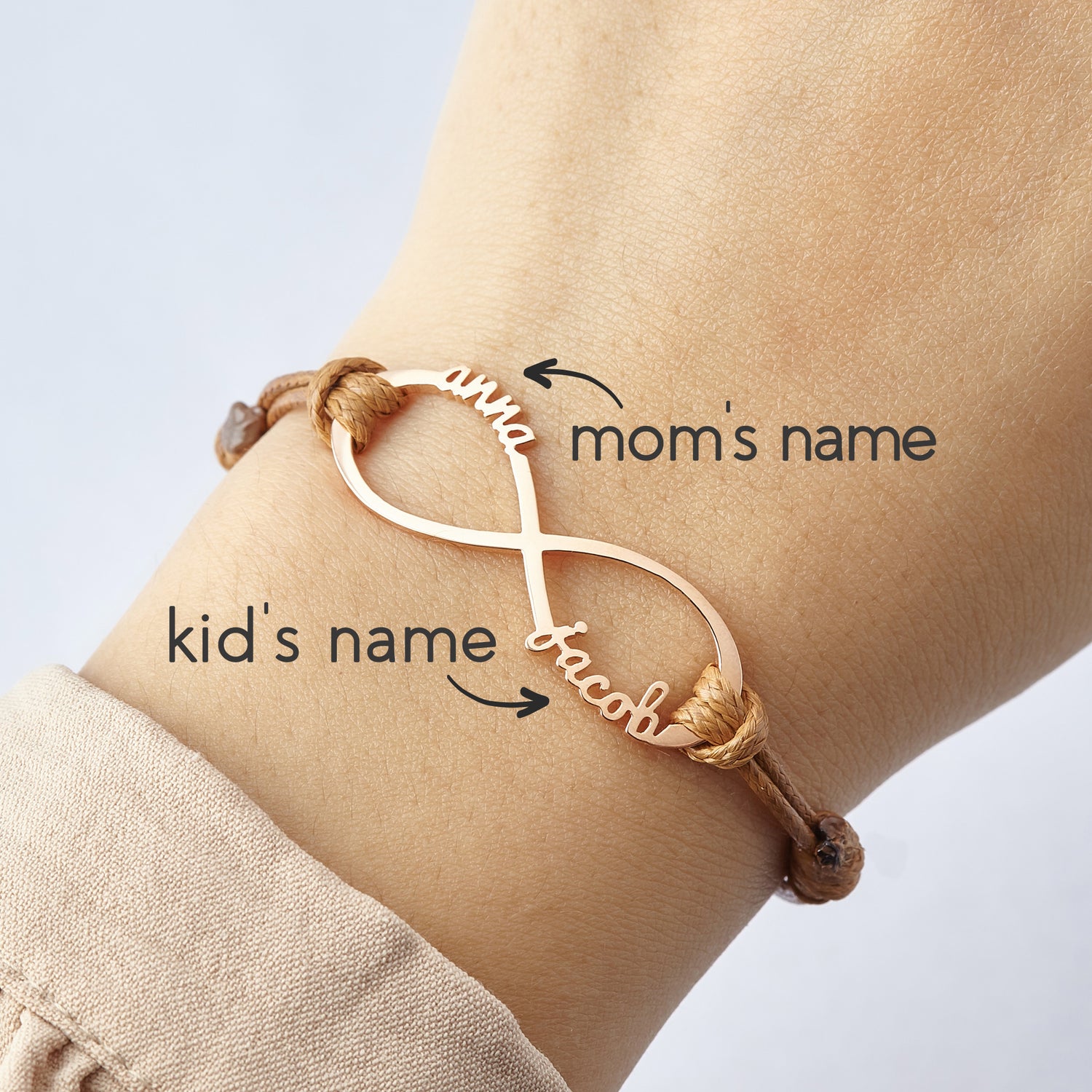 Green Millie mom bracelet with infinity design featuring engraved kids&