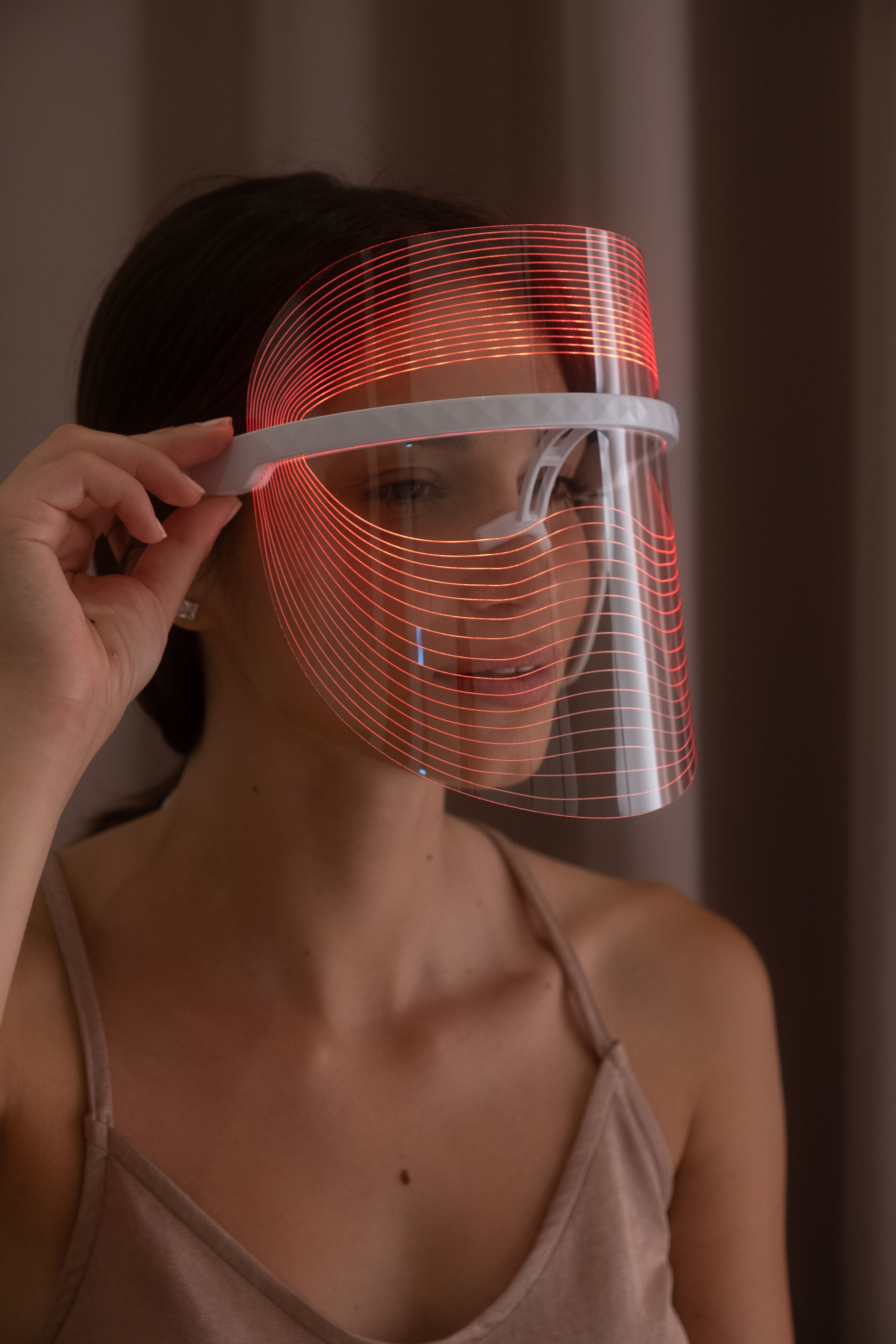 Scarlet Chrysippus Cocoon Skin Enlightenment LED Face Mask showing a sleek white healthcare mask with adjustable straps.