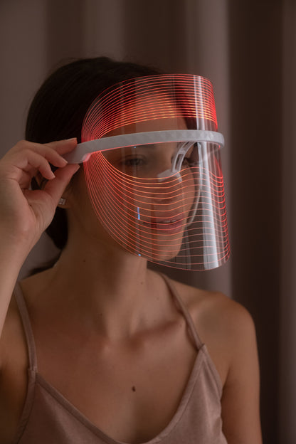 Scarlet Chrysippus Cocoon Skin Enlightenment LED Face Mask showing a sleek white healthcare mask with adjustable straps.