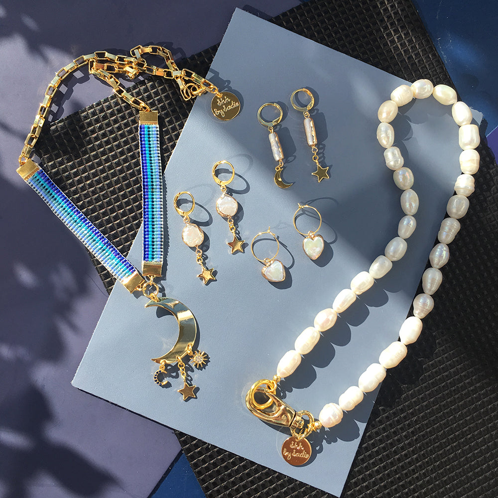 Yellow Athena crystal moon earrings featuring sparkling moon-shaped crystal pendants hanging from delicate hooks.