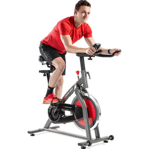 Teal Simba indoor cycling bike with 4-way adjustable handlebar and seat, LCD monitor for tracking workout metrics.