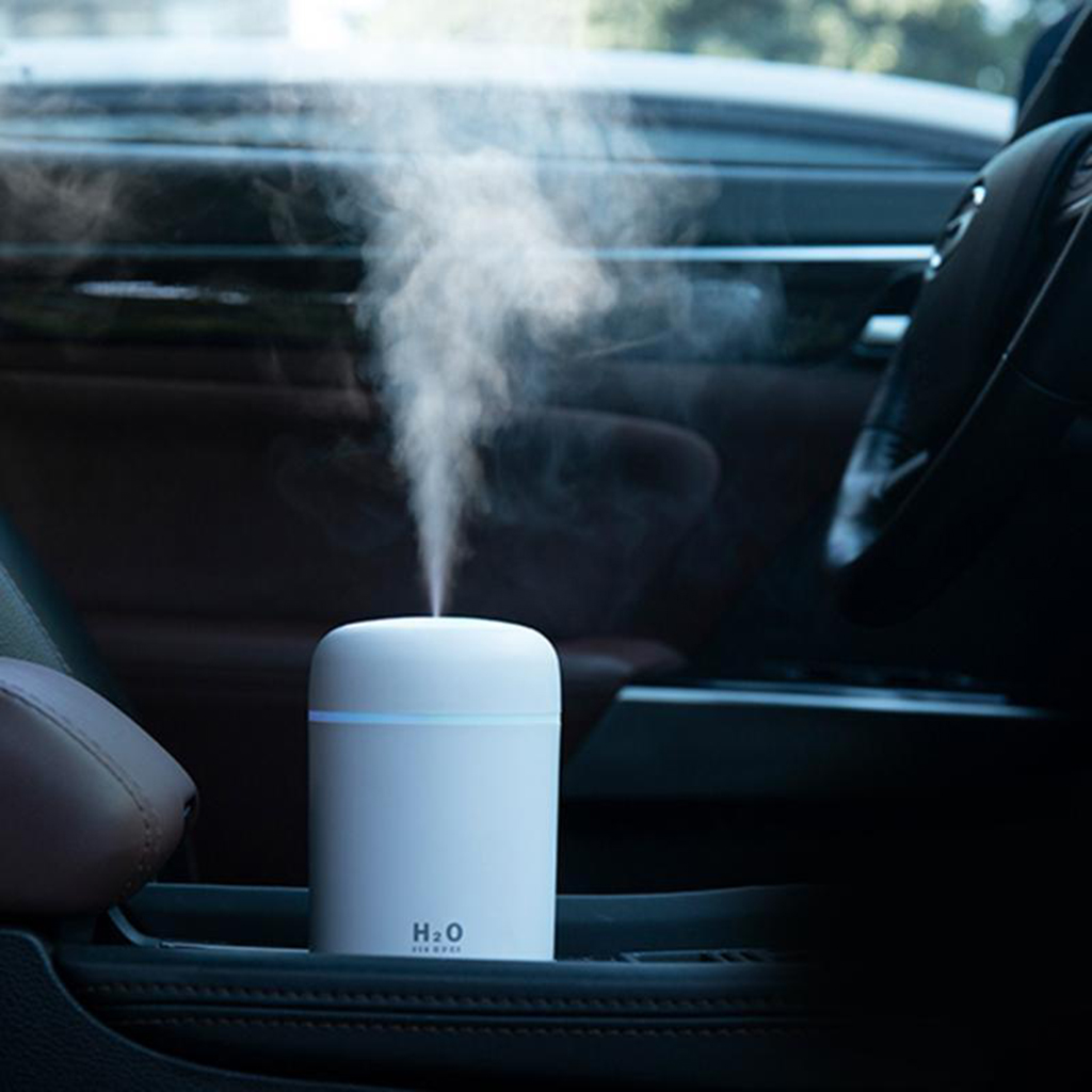 Teal Simba portable air humidifier and essential oil diffuser for car and home, with a sleek white design and adjustable mist outlet.