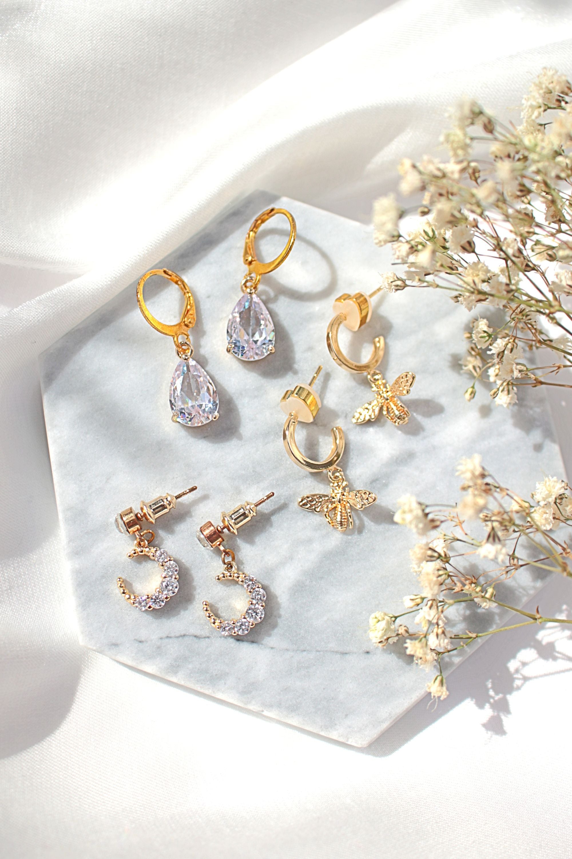 24 Karats Gold Bee Hoop Earrings by Ultramarine Birch featuring bee-shaped gold hoop earrings with intricate detailing.