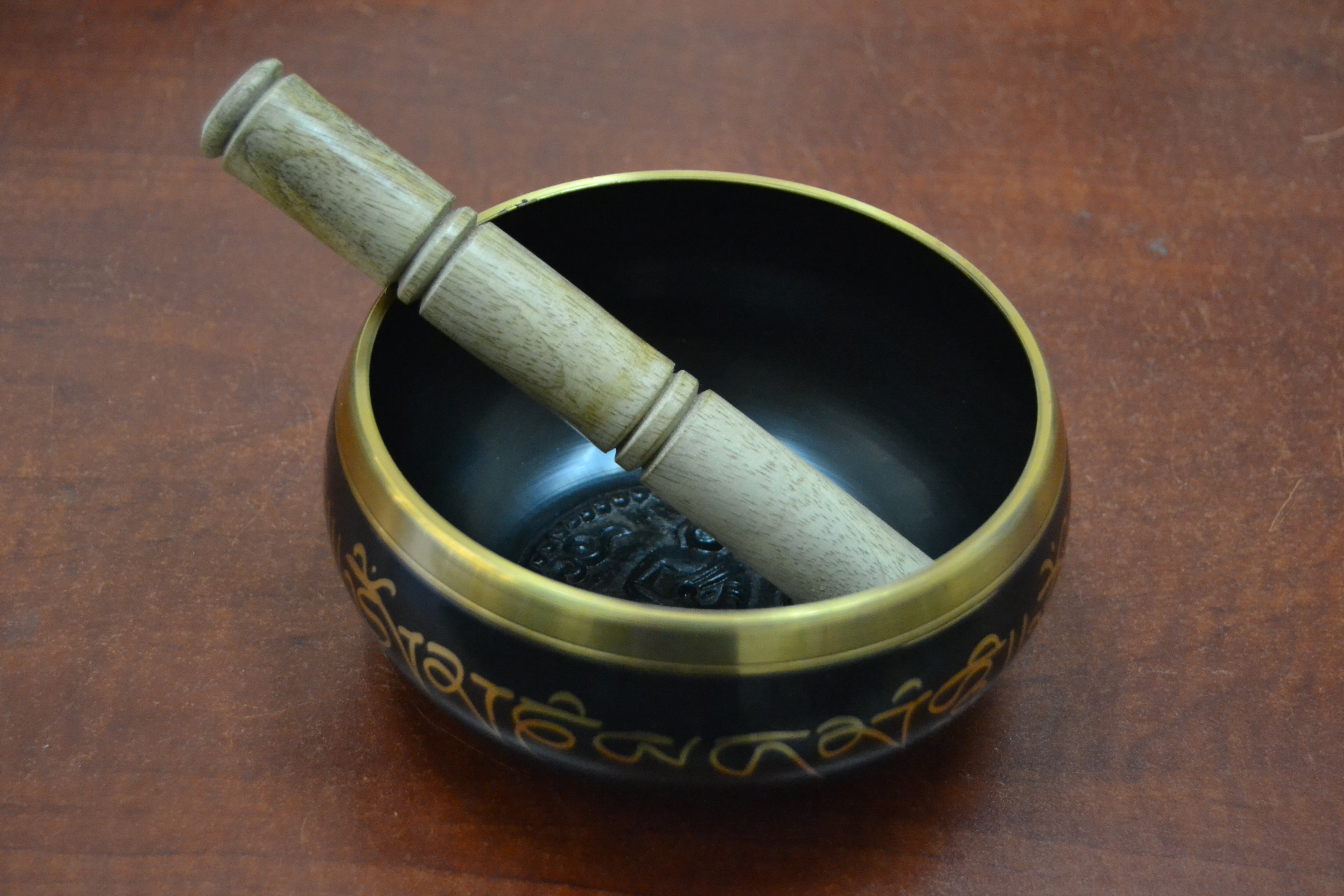 Handmade Nepal Tibetan Buddhist brass singing bowl with intricate carvings, used as a diffuser or decorative spiritual item.