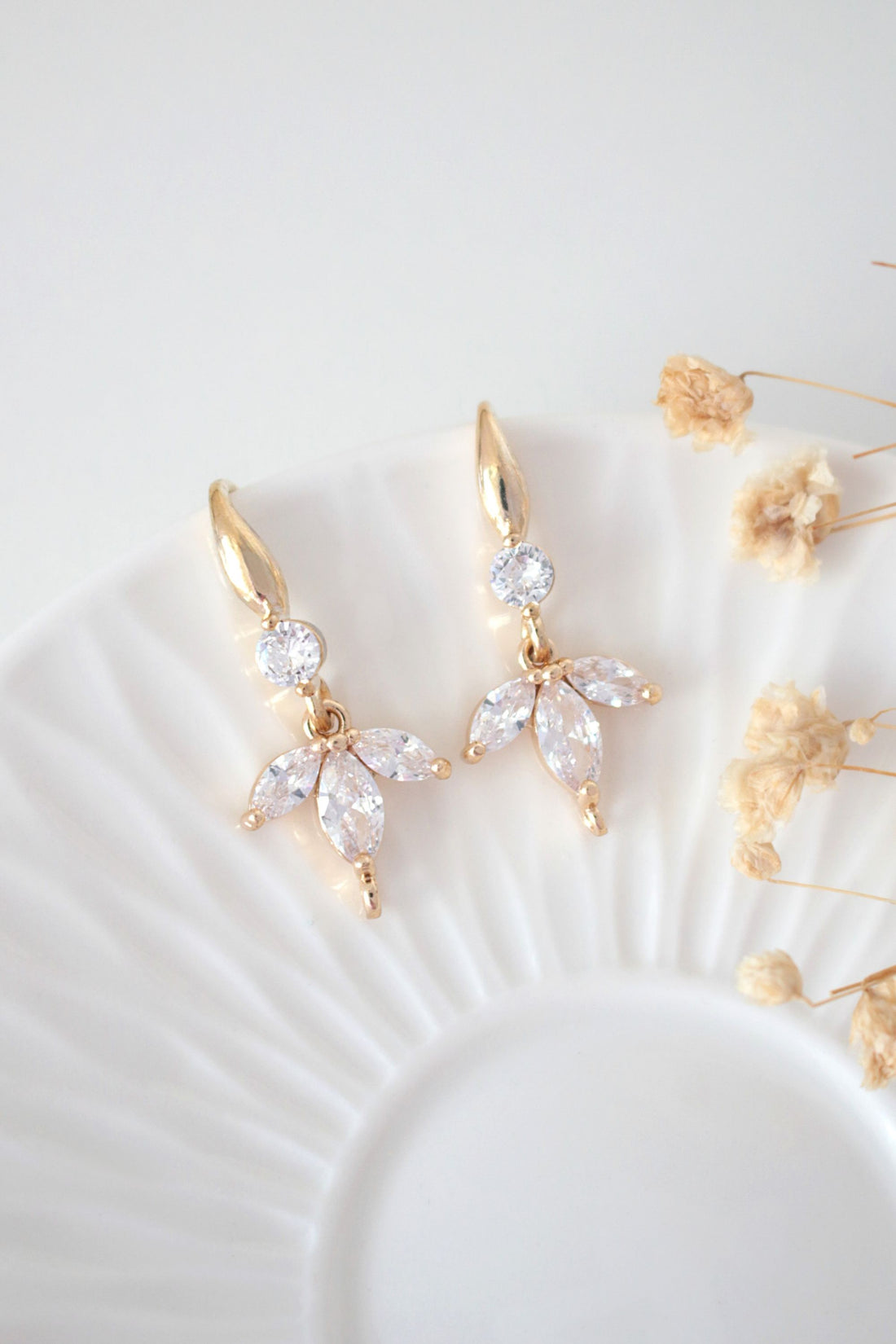 Ultramarine Birch "Bloom" cubic zirconia flower petal hook earrings featuring sparkling 24 karats gold-plated design