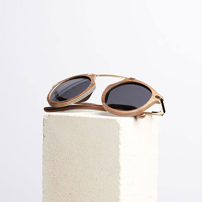 Fuchsia Artemis Santa Monica wooden sunglasses for women with rounded frames and natural wood finish.