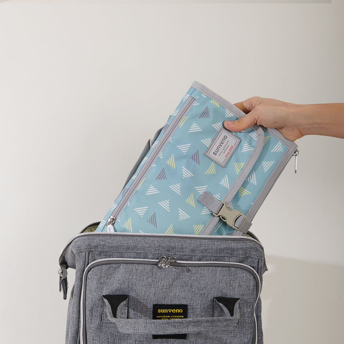 Maroon Chronos folding travel changing pad for kids and babies, compact and portable for on-the-go diaper changes.