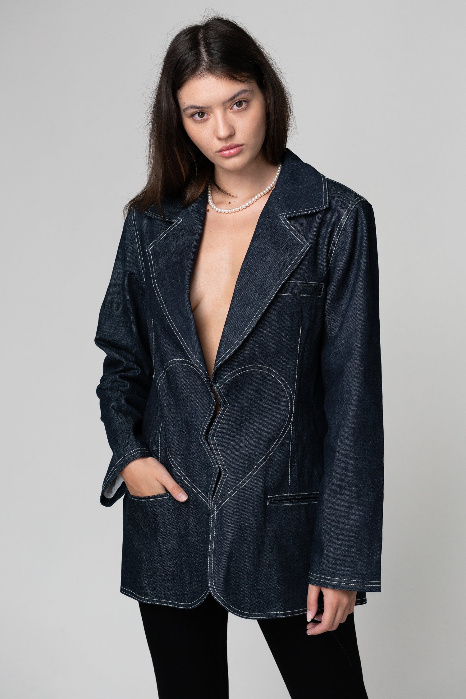 Brown Pontus broken heart denim blazer featuring distressed fabric and classic jacket silhouette, displayed on a hanger.