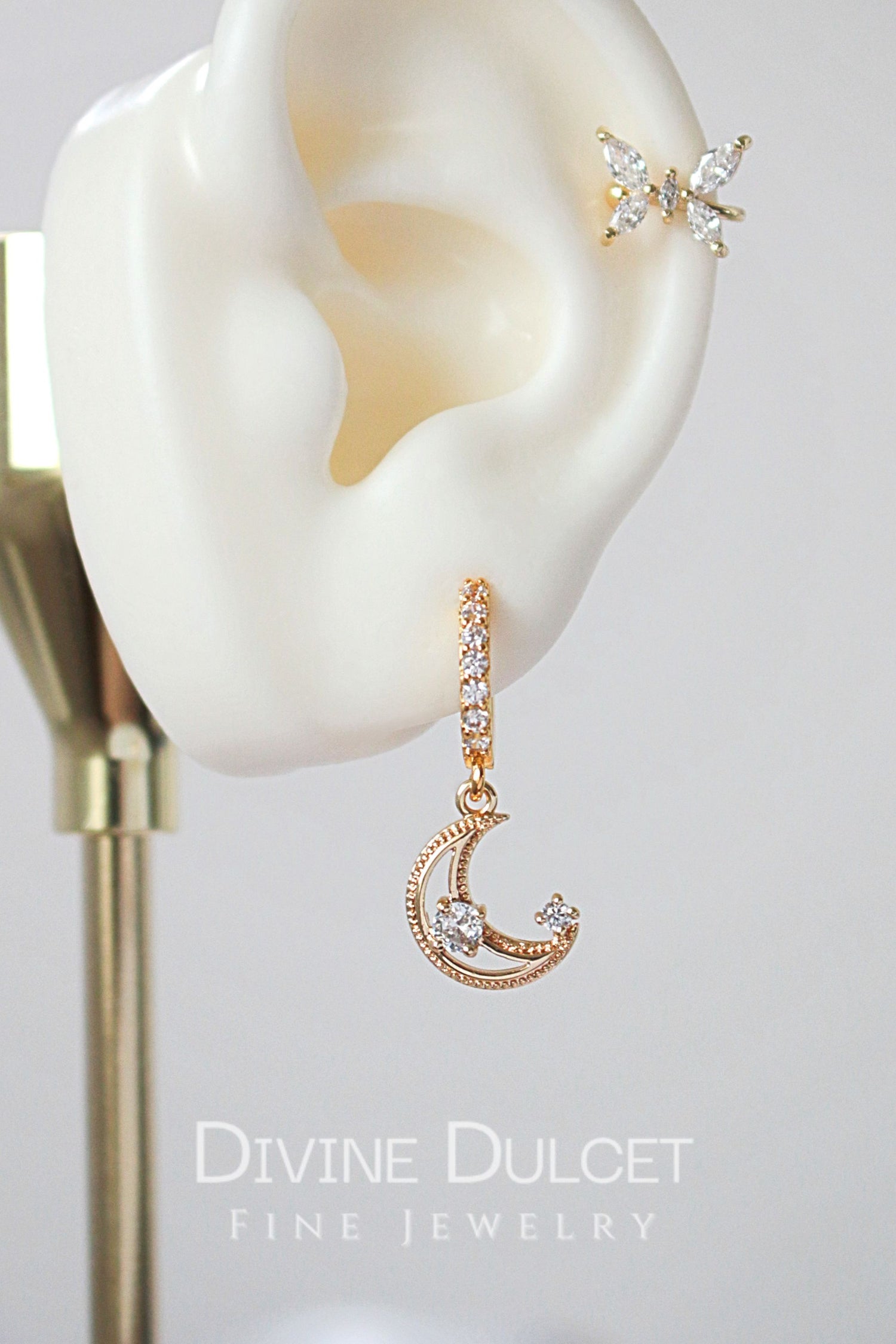 Ultramarine Birch 24 Karats Gold Cubic Zirconia Moon Hoop Earrings showing shiny gold hoops with zirconia accents