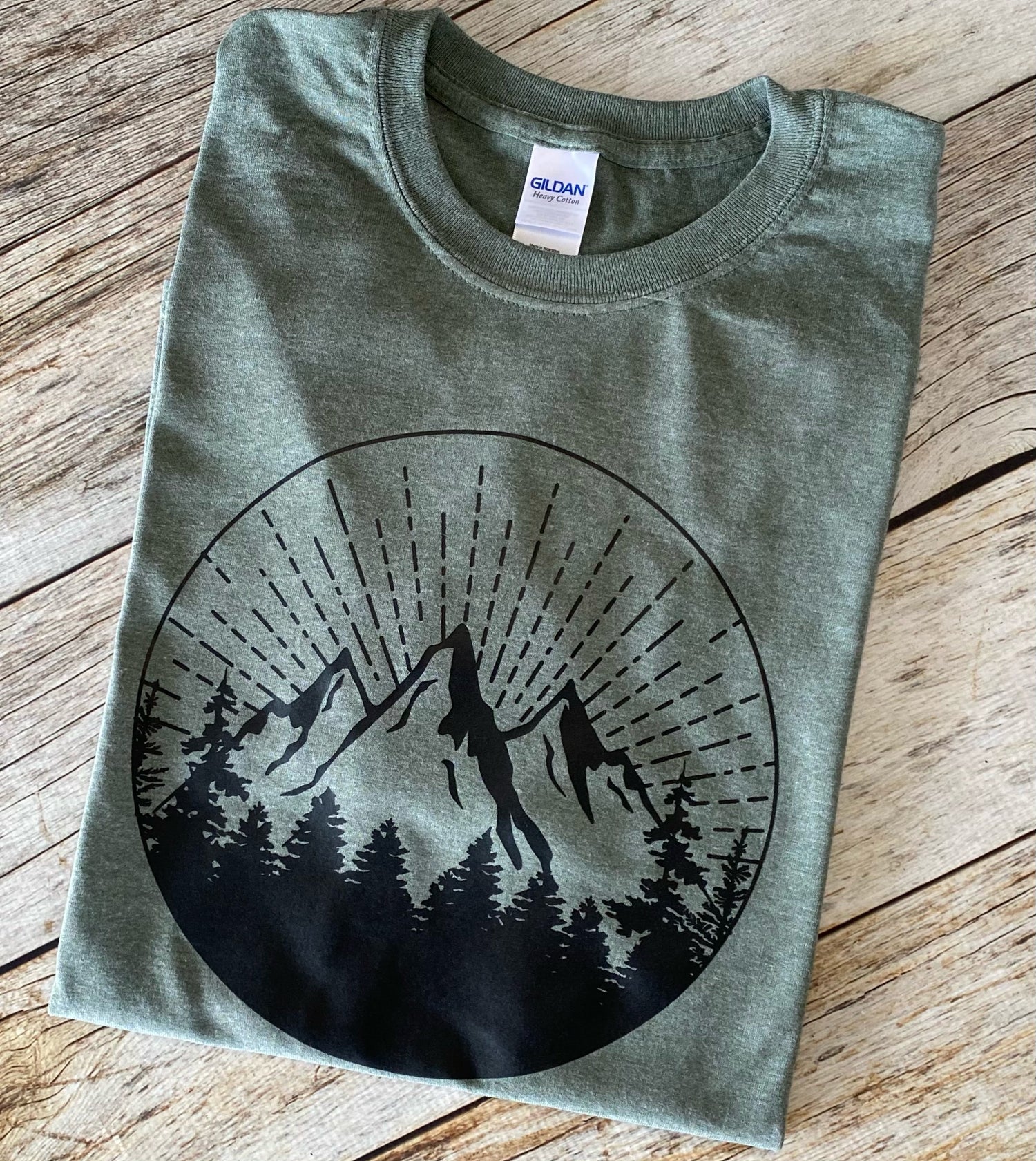 Copper Aion Mountain Sunrise T-shirt featuring a vibrant mountain landscape design on soft, comfortable cotton fabric.