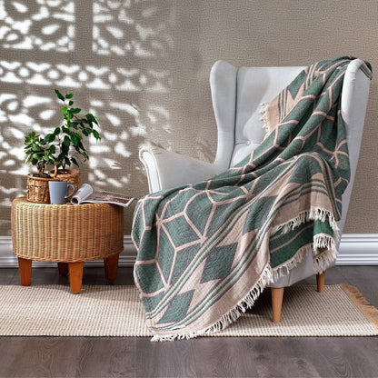 Olive Rose Ela Soft Jacquard Cotton Bedspread featuring intricate woven patterns, draped over a neatly made bed.