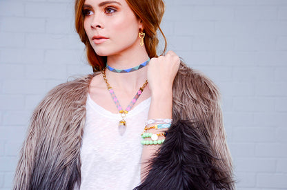 Yellow Athena Twilight bracelet with pink, orange, blue, and gold beads, featuring a delicate jewelry design.