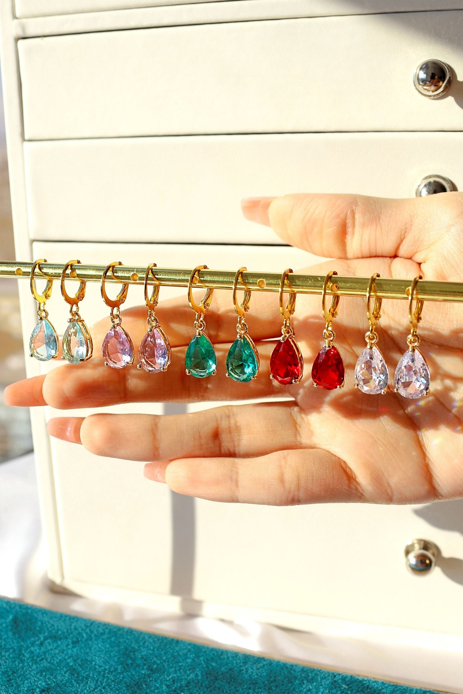 Ultramarine Birch 18K rainbow teardrop hoop earrings with vibrant, colorful glass teardrop charms on gold hoops.