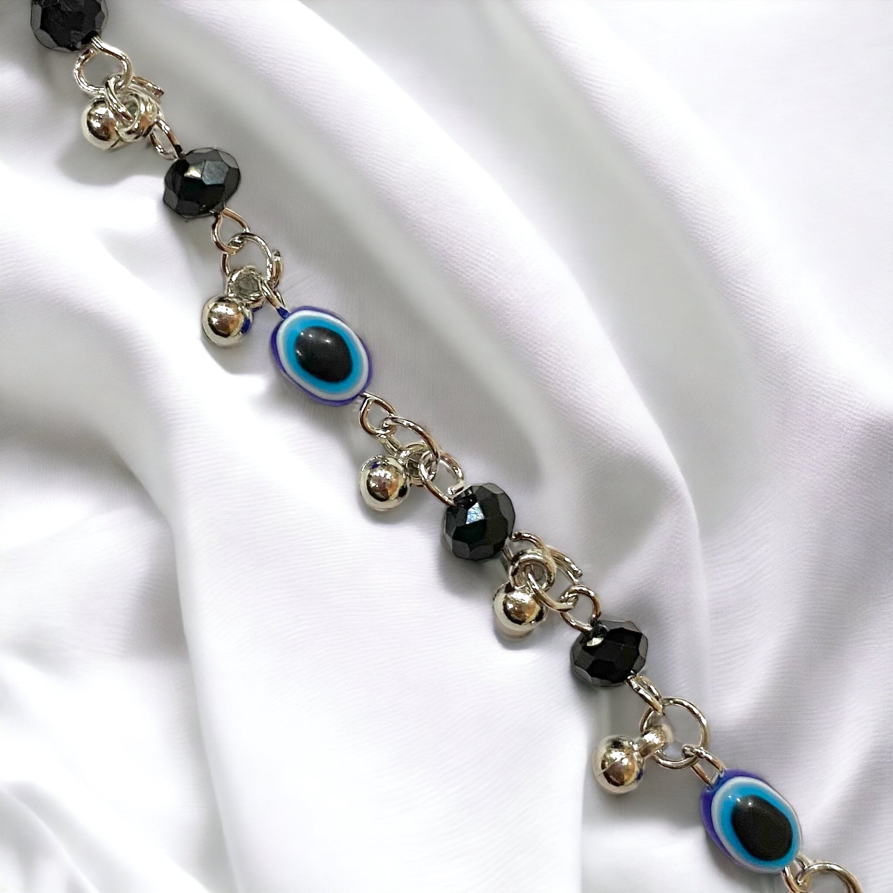 Gray Poseidon Fortune’s Shield Evil Eye bracelet featuring a protective blue and silver jewelry piece with intricate design detailing.