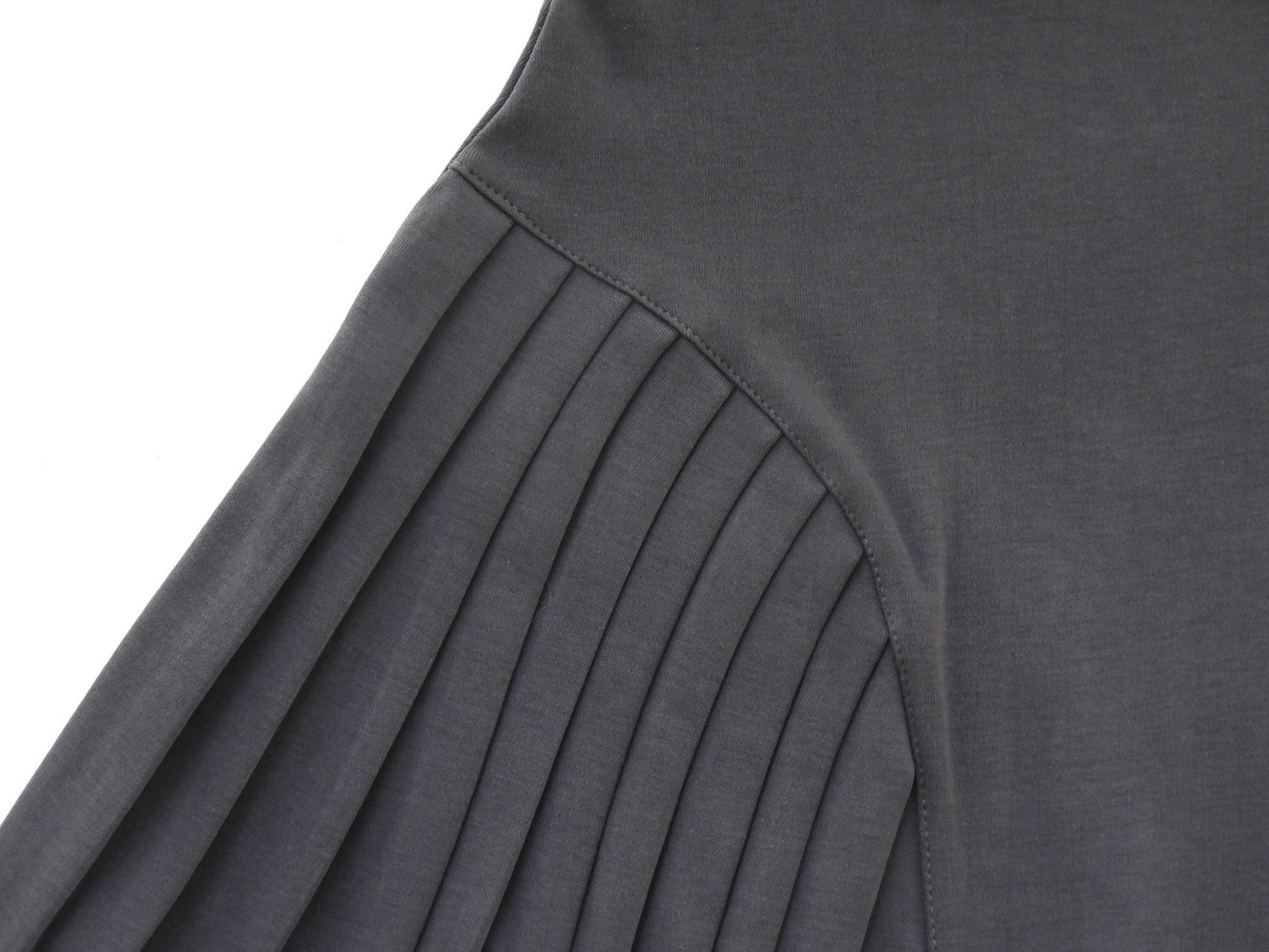 Emerald Hephaestus half-pleated mini skirt in black, shown on a model with a fitted waist and stylish design.