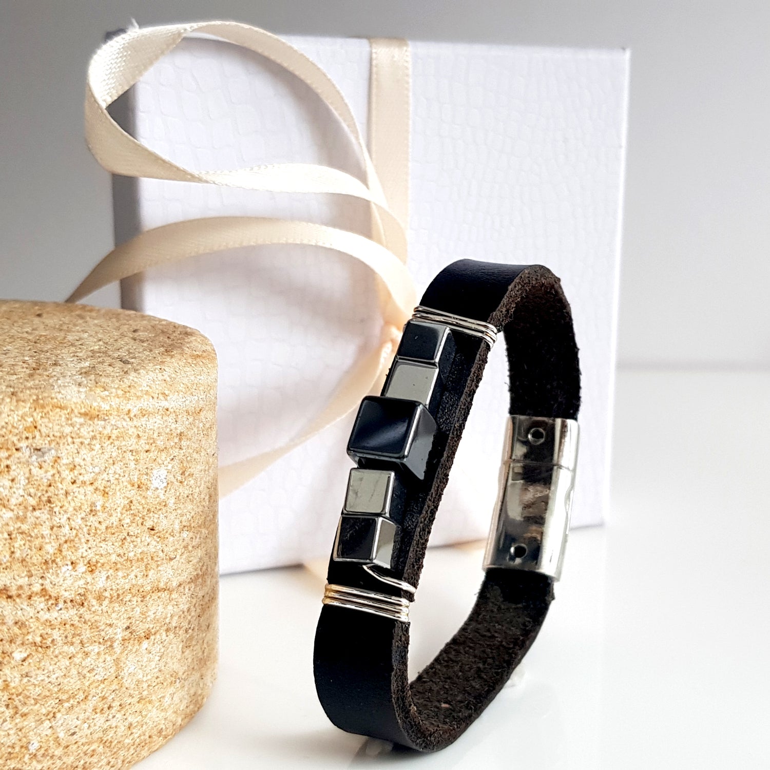 Large black leather and haematite band bracelet by Maroon Smudge, featuring smooth leather strap and metallic haematite accents.