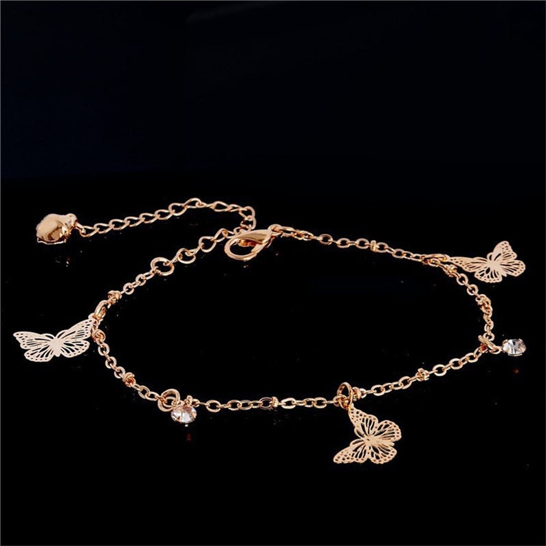 Silver plated butterfly Bohemia ankle bracelet with chain design from Red Iphigenia, styled as a fashionable accessory.