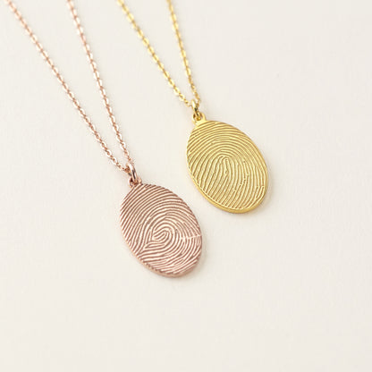 Green Millie fingerprint necklace with memorial thumbprint pendant, personalized jewelry featuring a detailed fingerprint design.