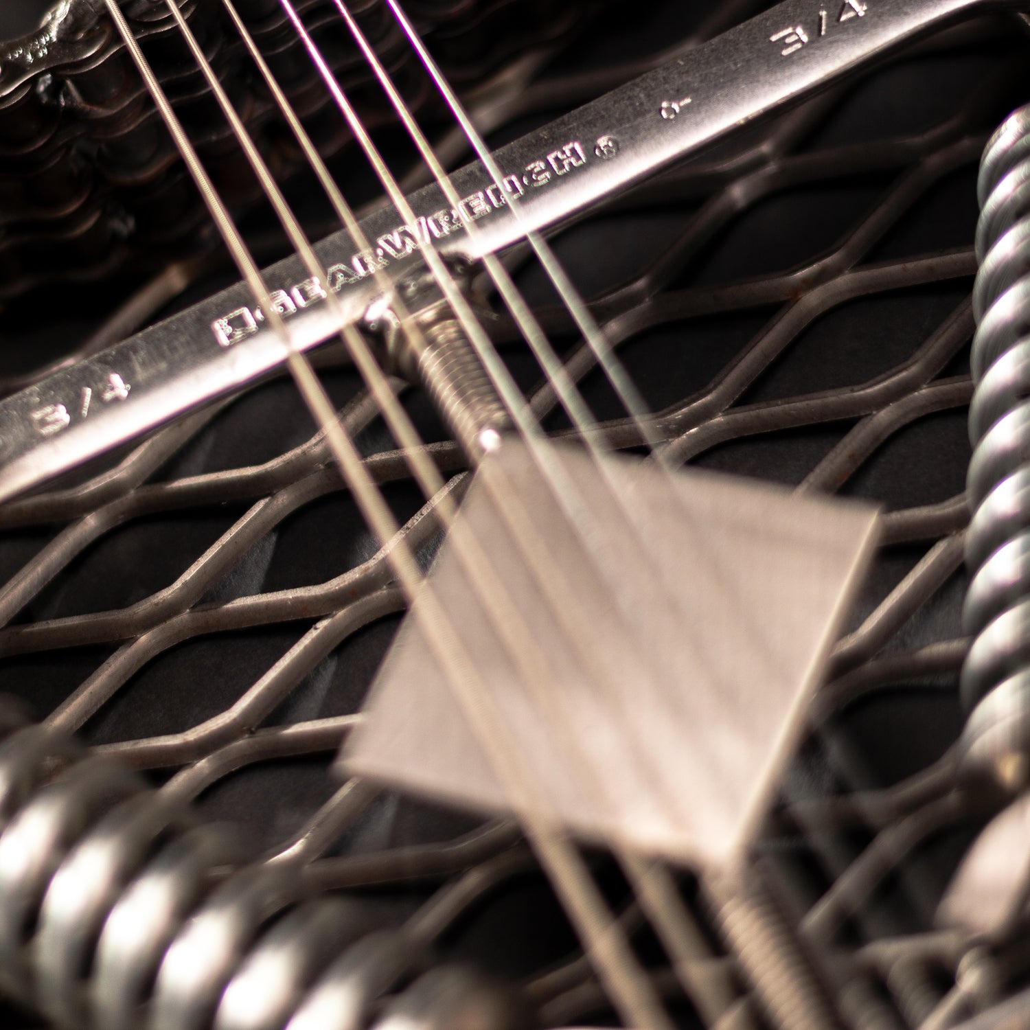 Metal electric guitar sculpture wall art by Turquoise Poppy, a heavy metal home decor piece with a sleek, artistic design.