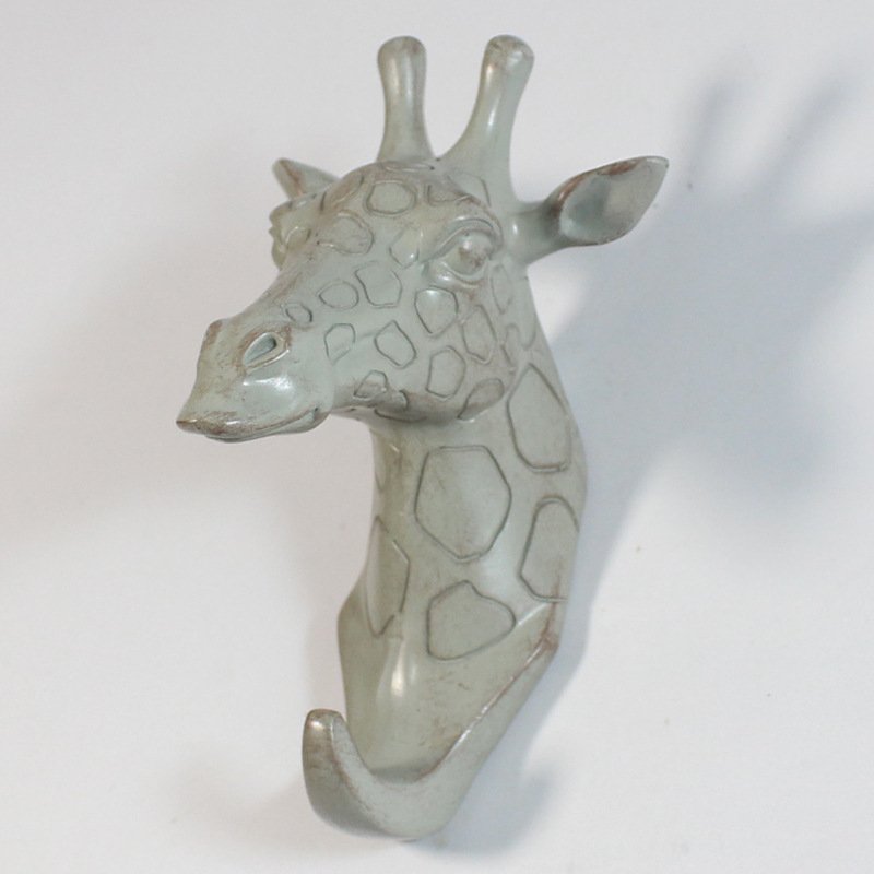 Fuchsia Molly resin giraffe head hook for home and garden decor, featuring a detailed giraffe head design with a functional hook.