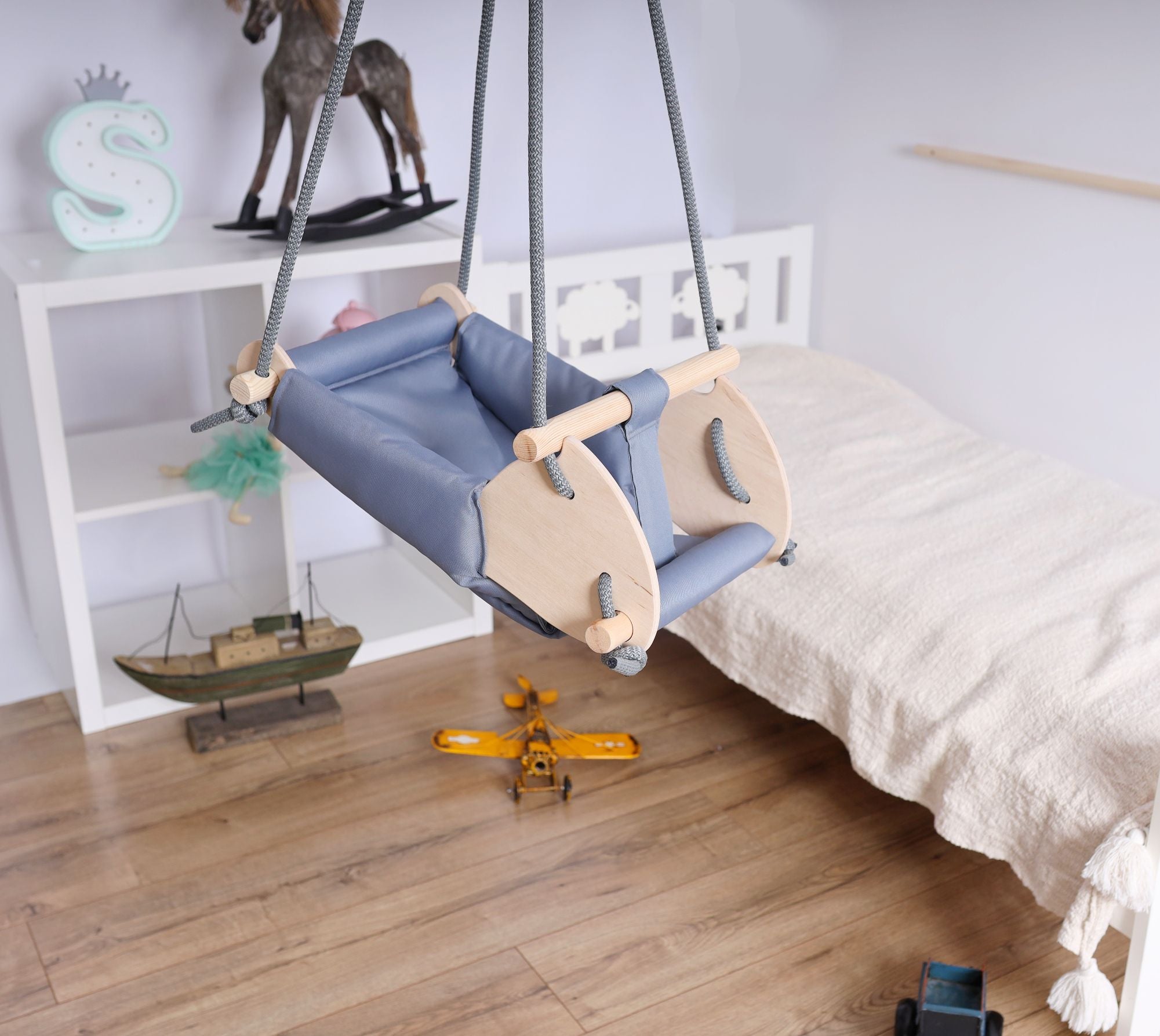 Ochre Ares kids and babies cradle swing with soft fabric and sturdy frame, designed for gentle rocking and comfort.