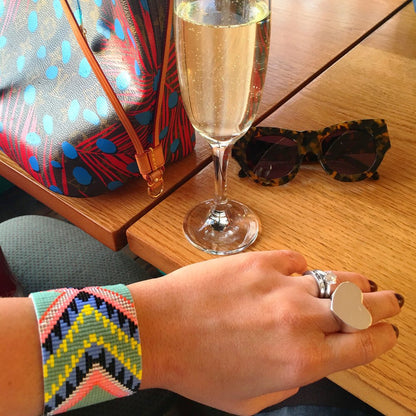 Yellow Athena XO Acapulco bracelet in white and khaki colors, featuring woven design and adjustable closure.