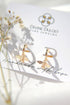 24 Karats gold bee hoop earrings by Ultramarine Birch, featuring detailed bee design on shiny gold hoops.