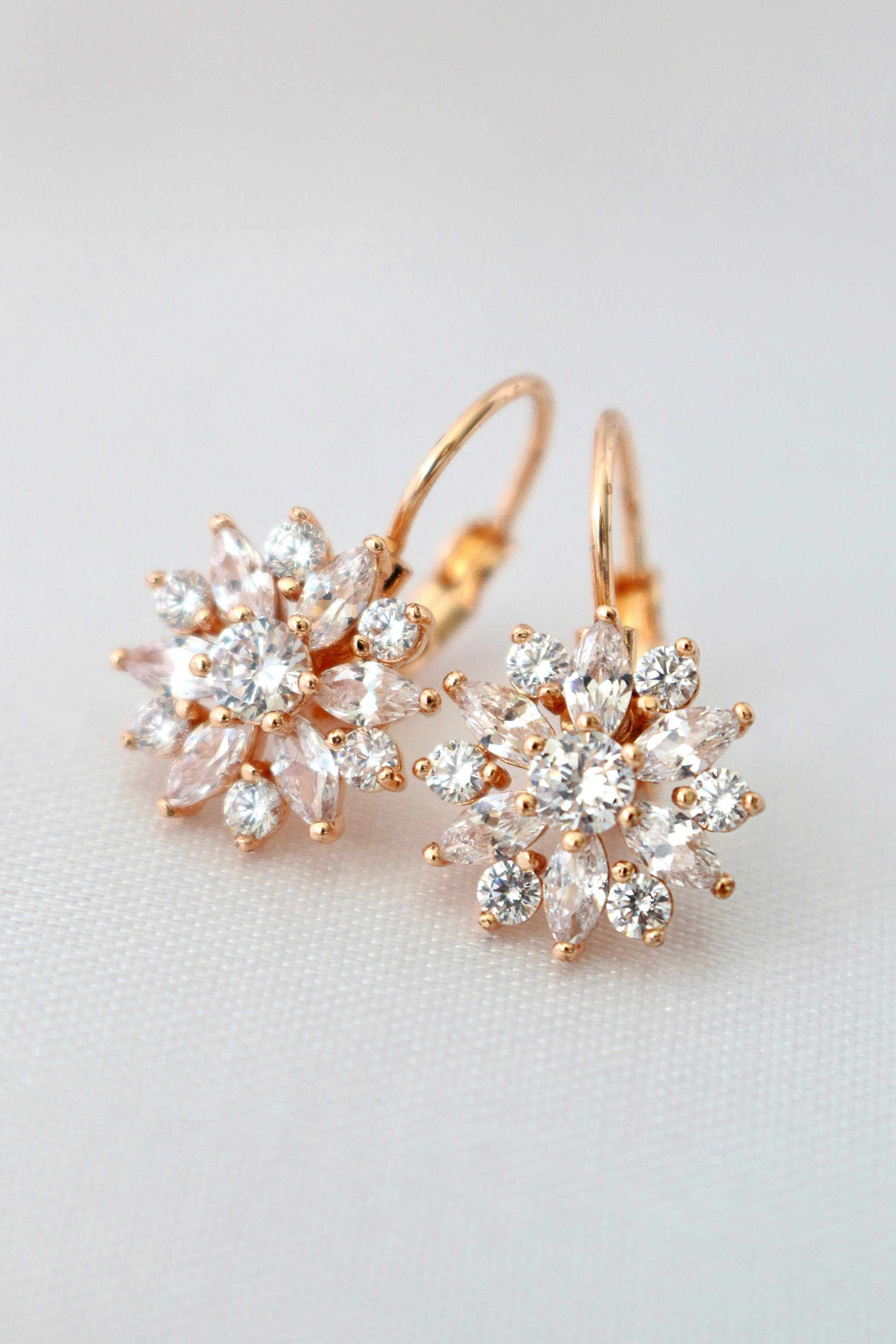 Diamond Sunflower Huggies earrings by Ultramarine Birch, 18K gold plated with sunflower and diamond details, close-up view.