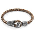 Taupe grey Alderney silver and braided leather bracelet by Magenta Sooty, featuring silver accents and intricate leather weaving.