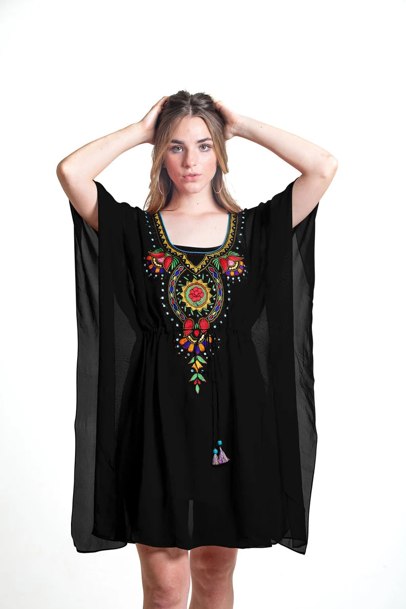 Black Mexican dress with embroidered details, flowing kaftan style by Erin Pontus, showcasing vibrant traditional embroidery and elegant design.