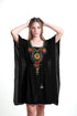 Black Mexican dress with embroidered details, flowing kaftan style by Erin Pontus, showcasing vibrant traditional embroidery and elegant design.
