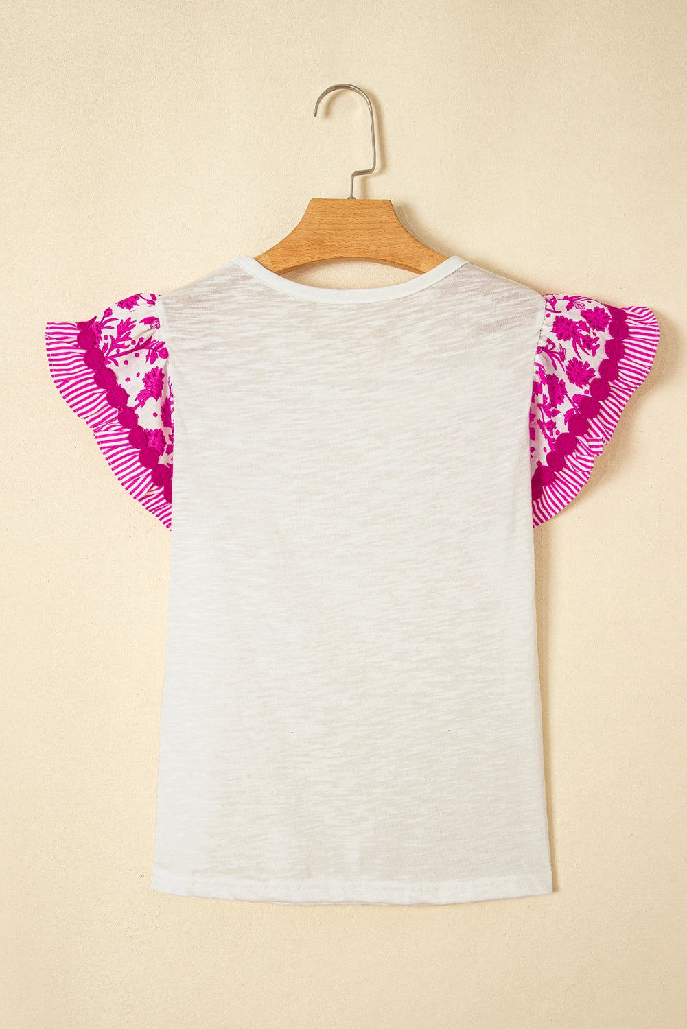 Byzantium Bay floral patchwork blouse with flutter sleeves and ricrac trim, featuring colorful floral patterns on lightweight women&