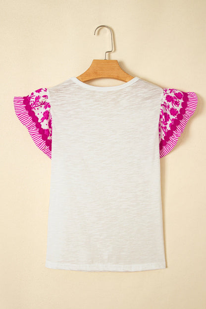 Byzantium Bay floral patchwork blouse with flutter sleeves and ricrac trim, featuring colorful floral patterns on lightweight women&