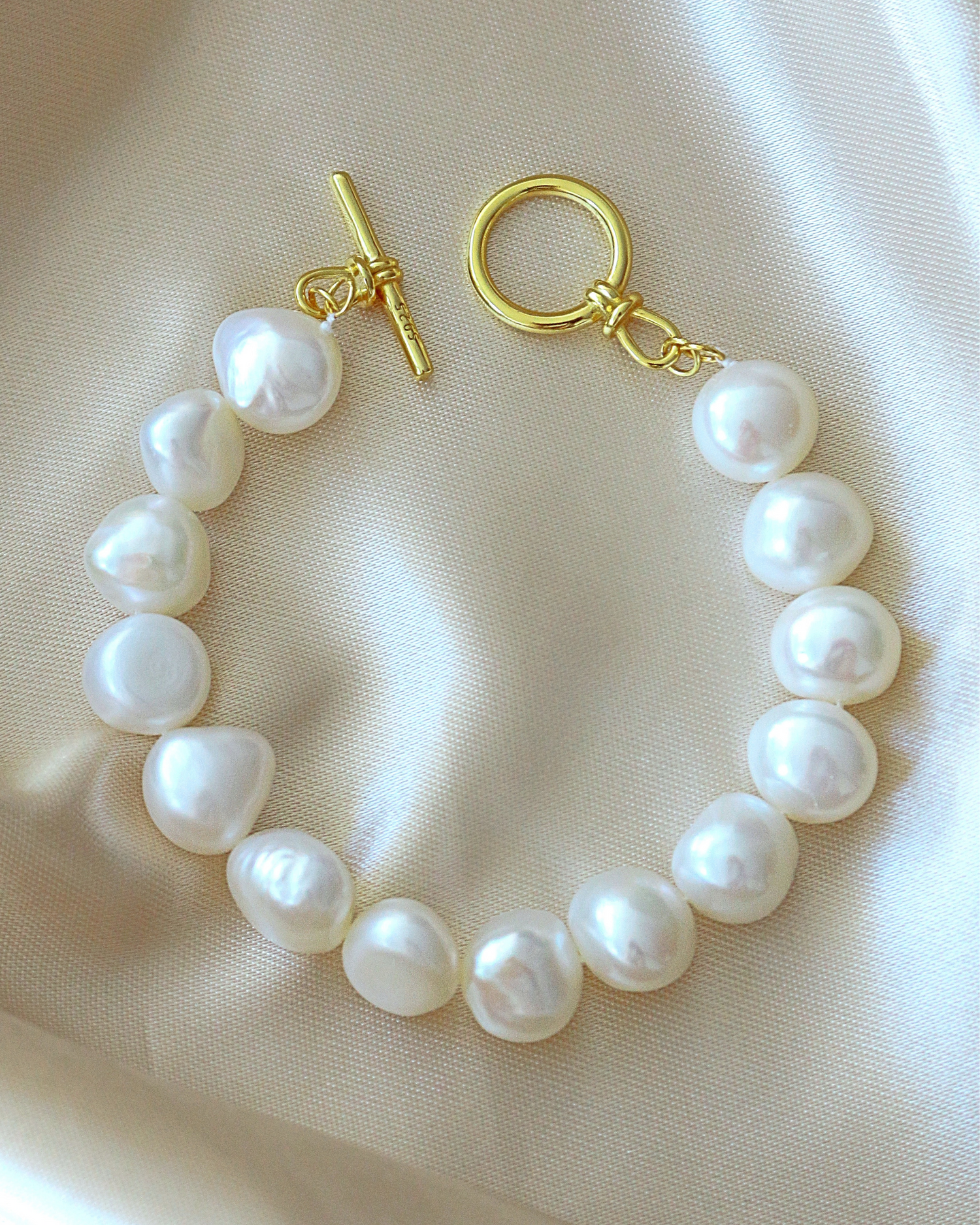 Ultramarine Birch Baroque freshwater pearl bracelet with 925 sterling silver clasp, featuring irregularly shaped pearls on a delicate silver chain.