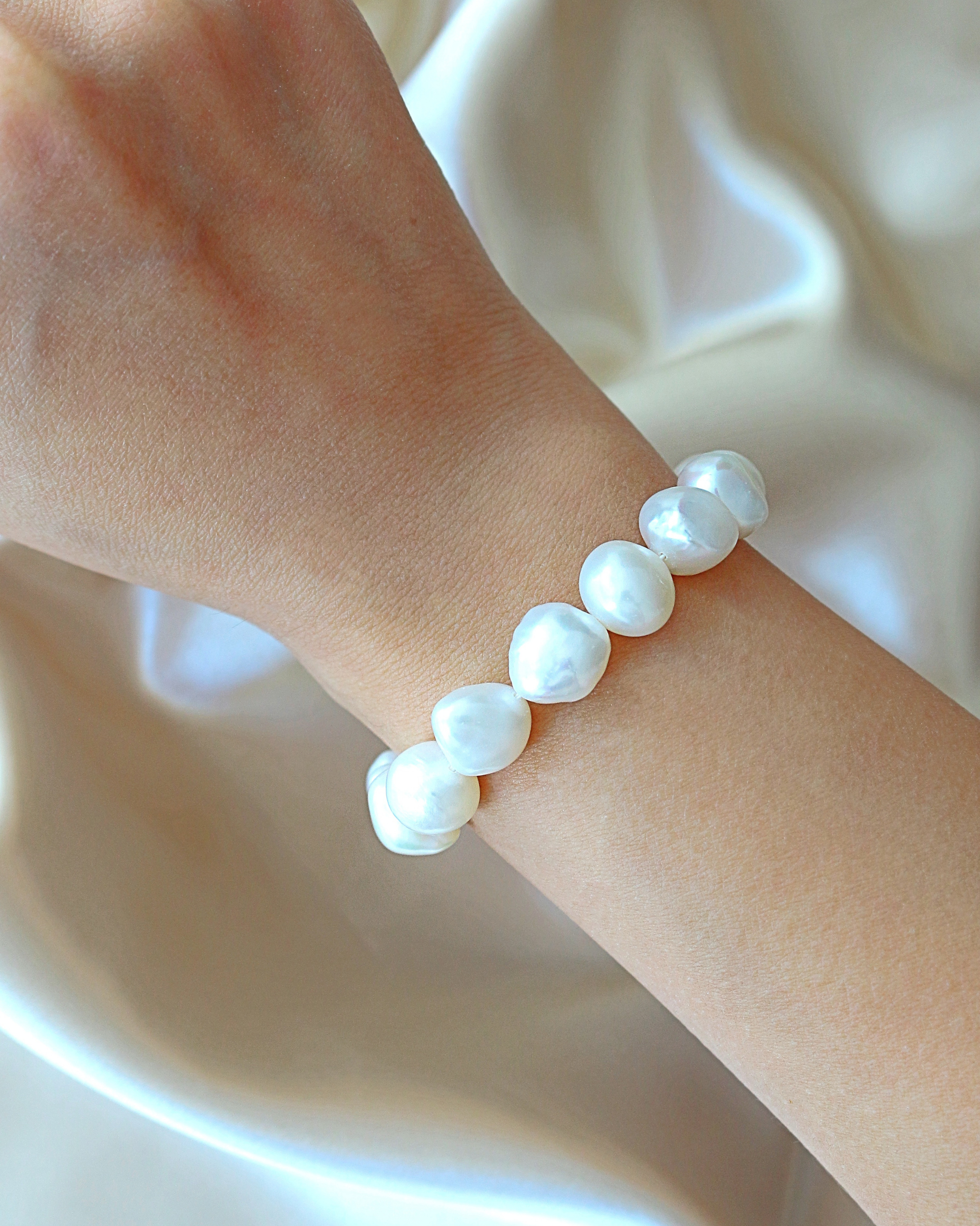 Ultramarine Birch Baroque freshwater pearl and 925 sterling silver bracelet with intricate pearl and silver details.