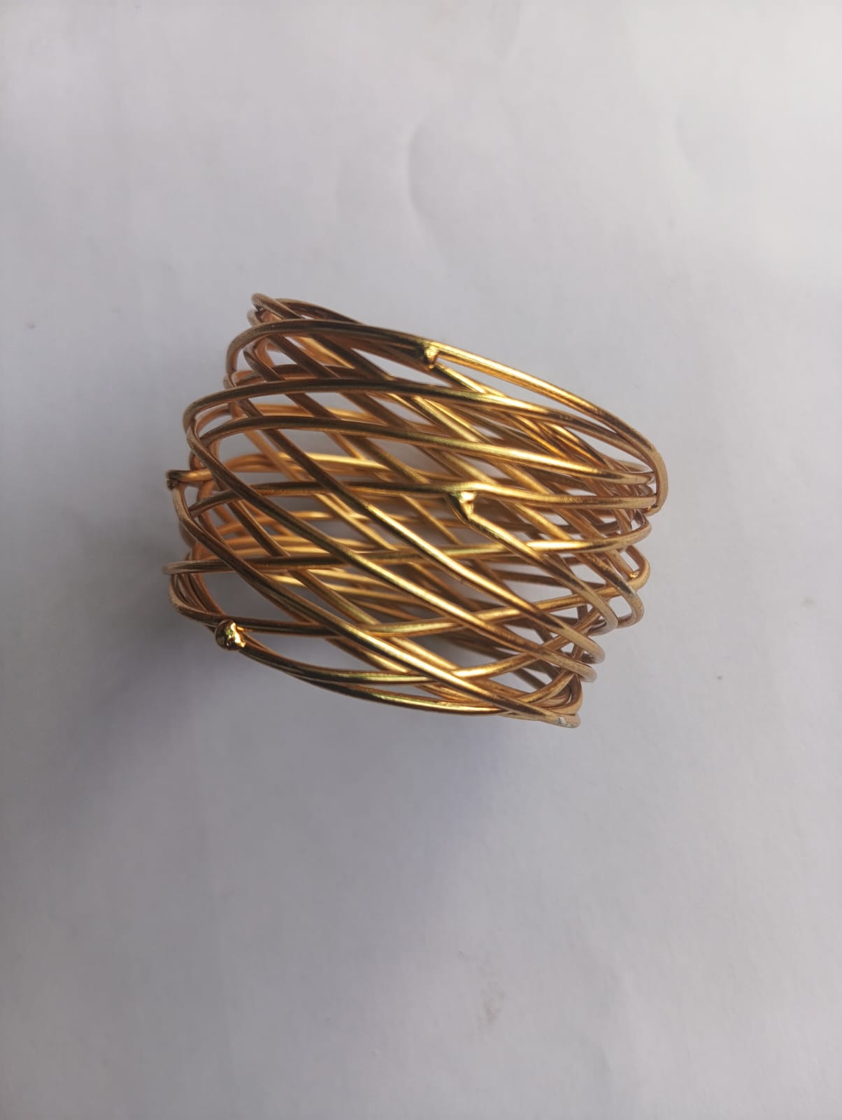 Gold Mash Wire napkin ring from Rose Broadleaf, showcasing a decorative gold wire ring for elegant table settings.