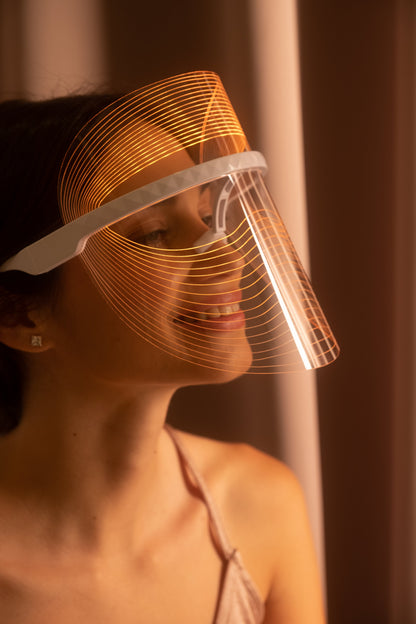 Scarlet Chrysippus Cocoon Skin Enlightenment LED Face Mask in black, with adjustable straps and LED light panels for skincare therapy.
