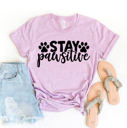 Agate Stay Pawsitive T-shirt featuring a positive message, casual fit, and comfortable fabric, displayed on a hanger.