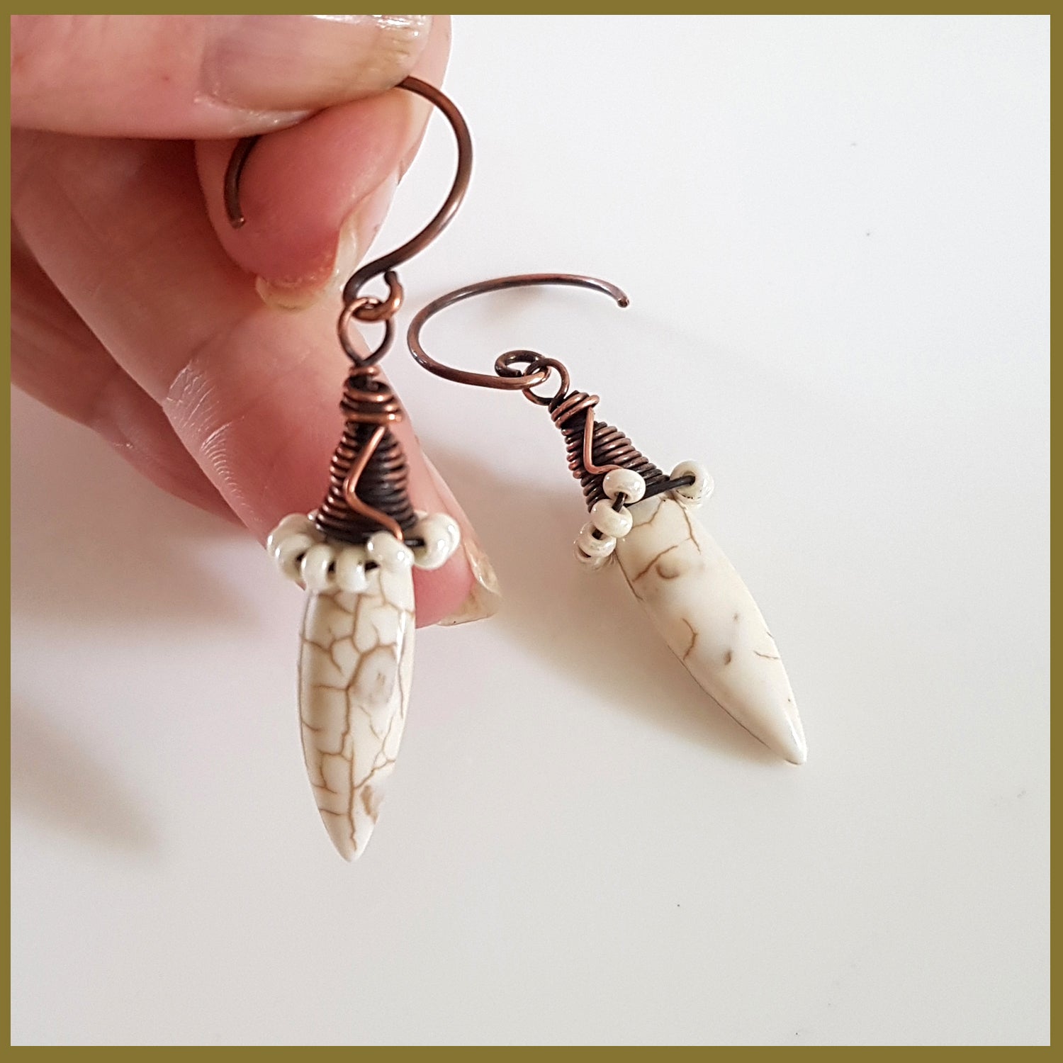 Copper wire wrapped Howlite spike earrings by Maroon Smudge featuring white spike stones and intricate wire detailing.