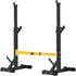 Teal Simba squat rack stand with barbell, free press bench, and dumbbell racks in a home gym setting.