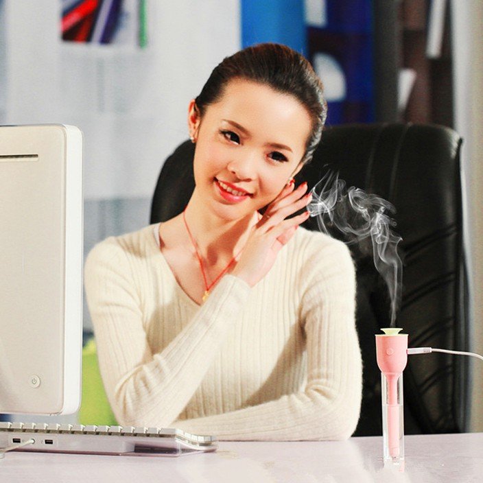 Fuchsia Molly Mini USB Magic Wand Humidifier in automotive use, showing compact design and nozzle for mist output.
