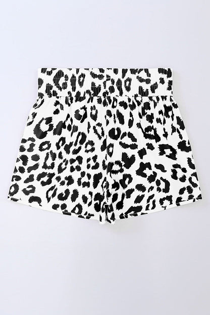 Byzantium Bay leopard and checker high waist athletic shorts displayed on a model, showcasing bold print and comfortable fit.