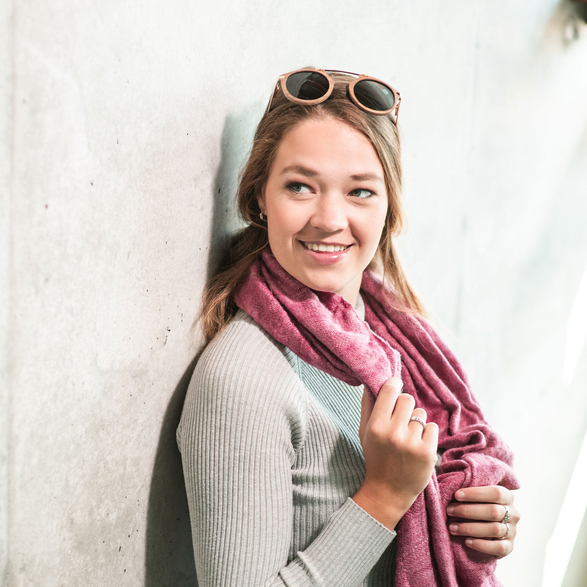 Fuchsia Artemis Santa Monica wooden sunglasses for women showing stylish frame and tinted lenses in a natural setting