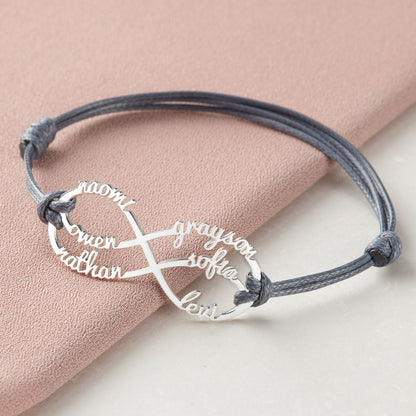 Green Millie mom bracelet featuring infinity design with engraved kids&