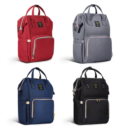Maroon Chronos fish-opening diaper bag unicorn backpack with multiple compartments and adjustable straps, designed for parents on the go.