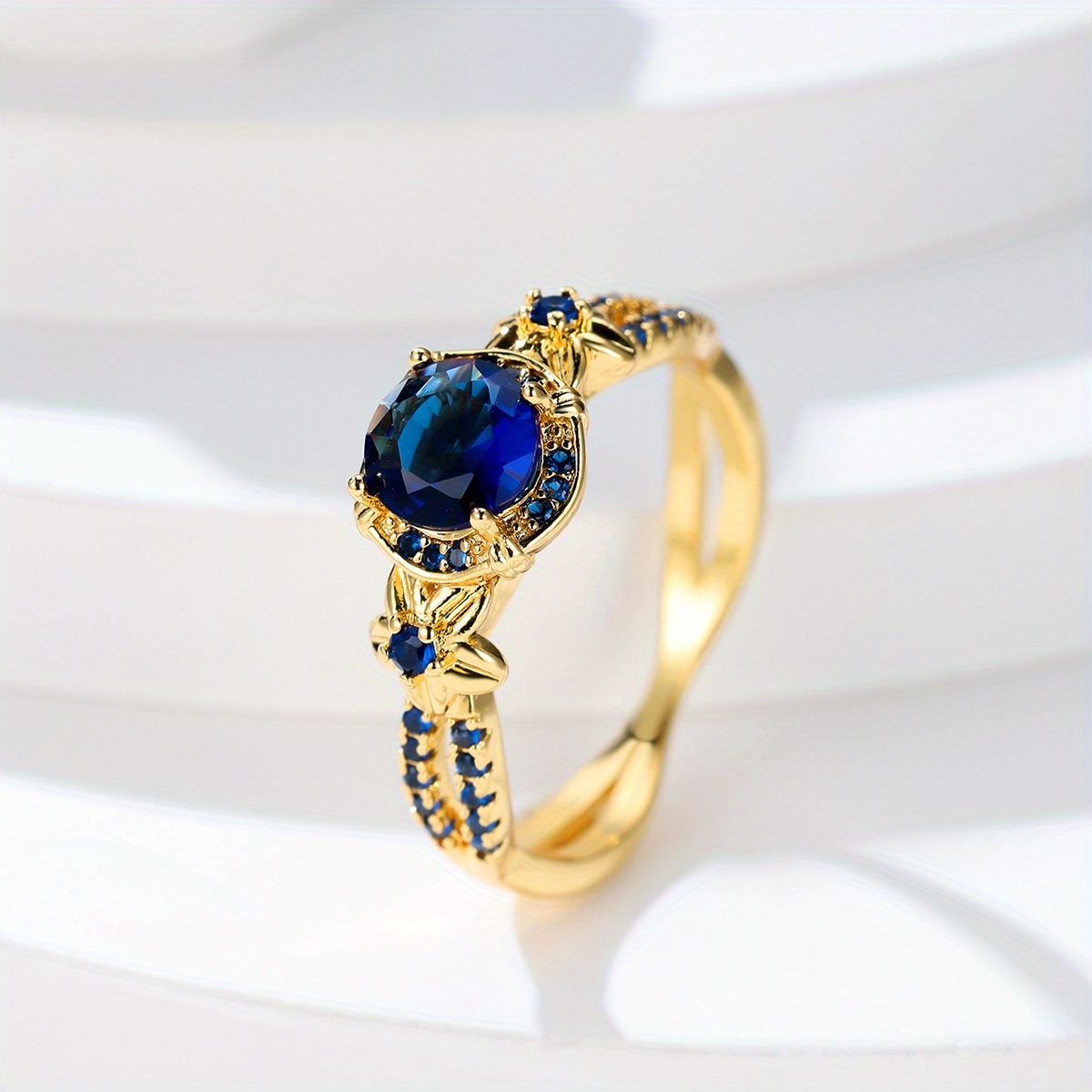 Carmine Medusa sapphire ring featuring a vibrant blue sapphire gemstone set in a silver band with intricate design details.